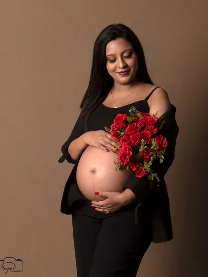 A beautiful bare-bump portrait. The modern, chic styling with a black blazer and pants is both powerful and elegant.