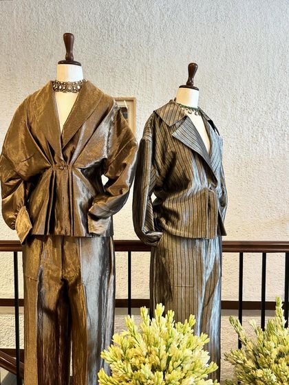 Another angle of the metallic co-ord sets, highlighting their liquid-metal-like texture and modern tailoring.