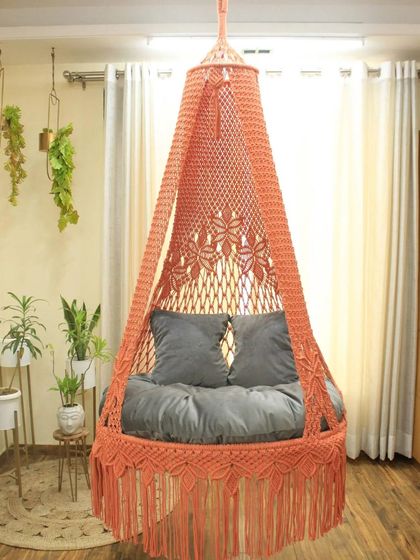 This single seater swing in a lovely peach color with grey cushions is a soft and stylish choice. It’s a beautiful piece for any corner of your home.