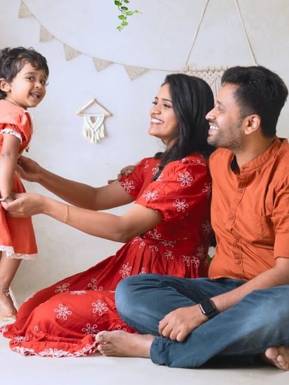 A candid moment of connection between parents and their child in the boho setup. The natural light and earthy tones create a soft and gentle mood.
