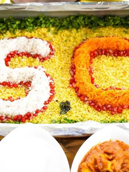 Personalization is key. For this event, I created a custom food art display with the client's initials 'SC' using pomegranate seeds and grated coconut, adding a special touch to their celebration.