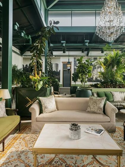 This sneak peek of the Paras Sales Office shows a conservatory-inspired space designed as a peaceful escape. The interior is filled with lush greenery and elegant furniture, setting the stage for a sophisticated and comfortable client experience.