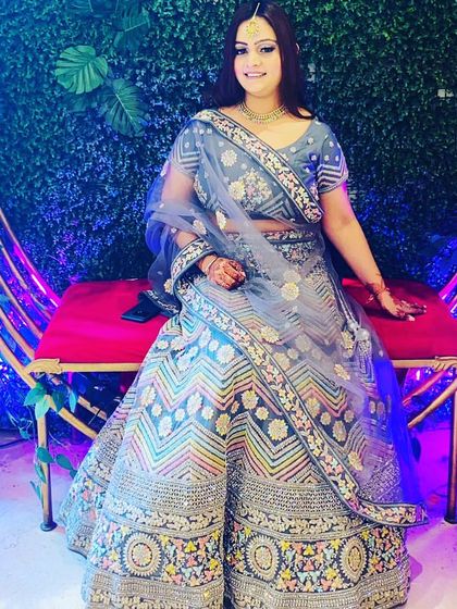 Another client looking beautiful in the grey multi-color lehenga. The intricate patterns and colors make it a very special piece.