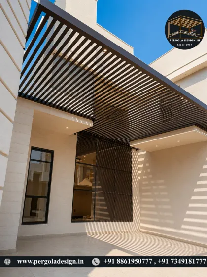 A sleek, modern pergola with a louvered roof, seamlessly integrated into the architecture of the house. The design provides shade for the entrance and carport area.