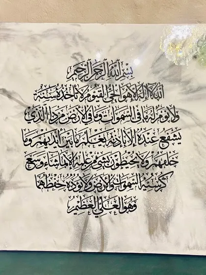 This is a close-up of the Ayat Ul Kursi wall art with a white marble effect. It shows the intricate glass embellishments in soft white, light blue, and pink, which add a unique touch of serenity.