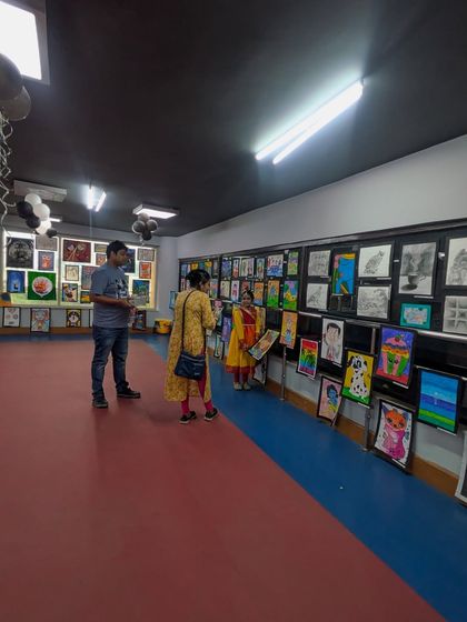 Visitors admiring the extensive collection of student art. Our exhibition provides a platform for students to share their work with a wider audience, building their confidence as artists.
