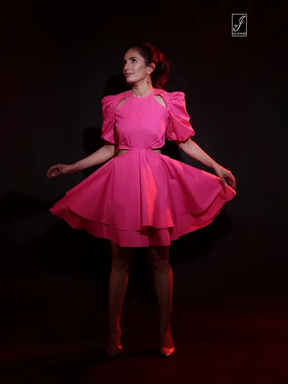 A dynamic shot capturing the movement of the pink dress, showing its playful and flared silhouette.