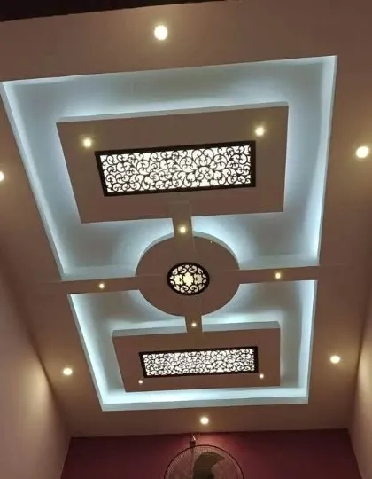 A symmetrical design with two 'jaali' or lattice panels. The central medallion is designed to hold a fan or a light fixture, blending function with ornate detail.