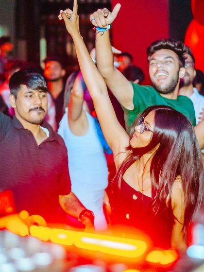 The crowd right up against the DJ booth, hands in the air. The energy is tangible.