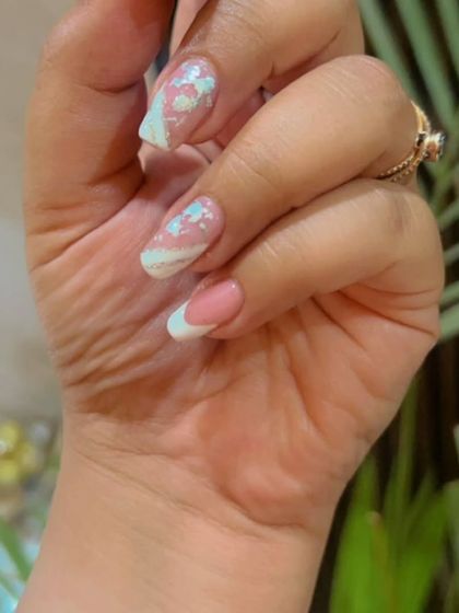 A closer view of the light blue and silver foil French manicure, showing the detail of the foil placement.