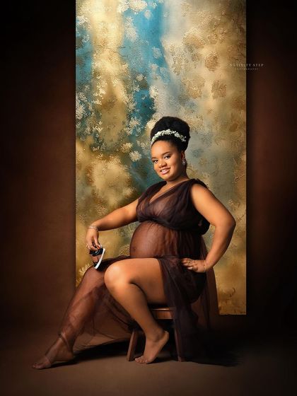 A confident and beautiful portrait in a sheer brown gown. The artistic painted backdrop adds a splash of color and texture.