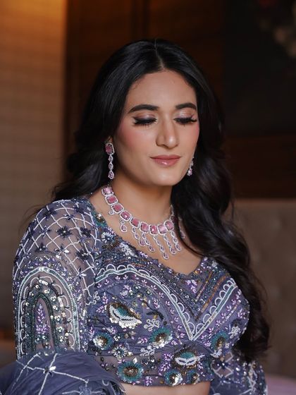 Learning to create elegant engagement or reception looks is a key part of my pro course. This look features soft purple tones on the eyes, paired with a radiant skin finish and a complementary pink necklace.