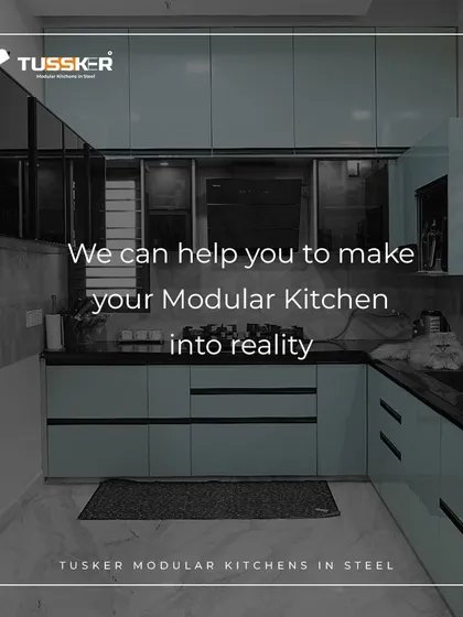 I can help make your modular kitchen a reality. This cool-toned, blue-grey kitchen demonstrates a sleek and modern aesthetic, proving that steel kitchens can be customized to fit any color palette.
