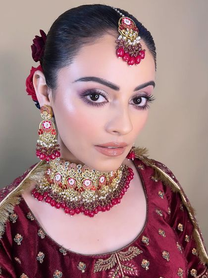 A stunning bridal portrait with dramatic eyes and glossy lips. This look is perfect for the bride who wants to make a statement.