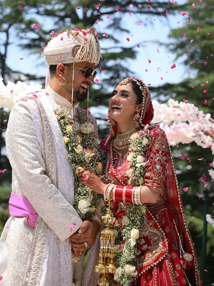 The pure, uninhibited laughter between a couple right after the ceremony, with petals falling around them and the open sky of Shimla above. These are the moments of pure bliss.
