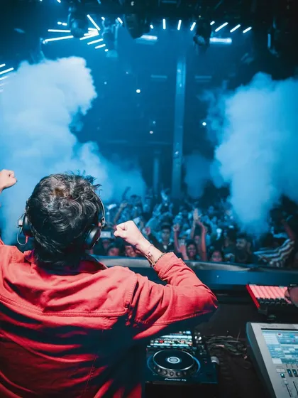 From behind, with both fists in the air, feeling the energy of the Goa crowd.
