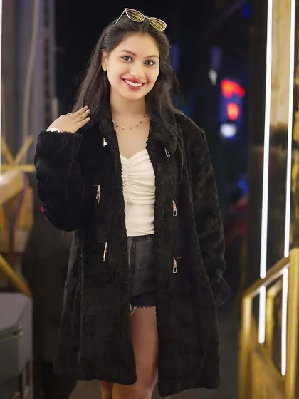 A guest in a stylish fur coat, ready for a fashionable night out.
