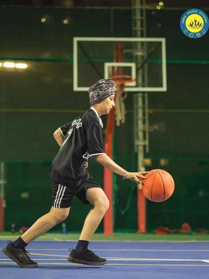 A player dribbles down the court with speed and control. I train athletes to make waves and stand out in the world of basketball.