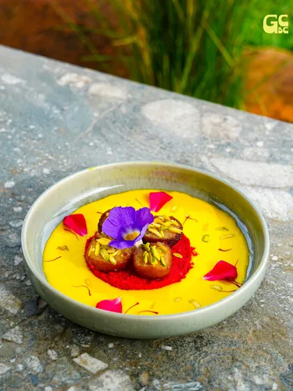 Our desserts are designed to be as beautiful as they are delicious. This vibrant dish features a sweet base adorned with edible flowers and pistachios, a perfect end to any meal.