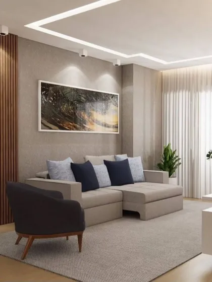 This living room uses a neutral color palette with pops of blue in the cushions. The fluted wood paneling adds texture and warmth to the space.