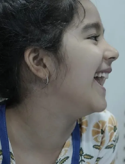 A candid shot of a student's infectious laughter. These are the moments of pure, unscripted joy that make the process so special.