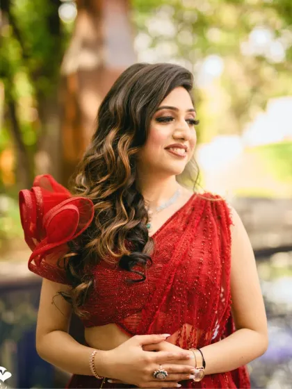 A candid, smiling shot of the bride. Her makeup is soft and natural, allowing her joyful expression to be the focus.