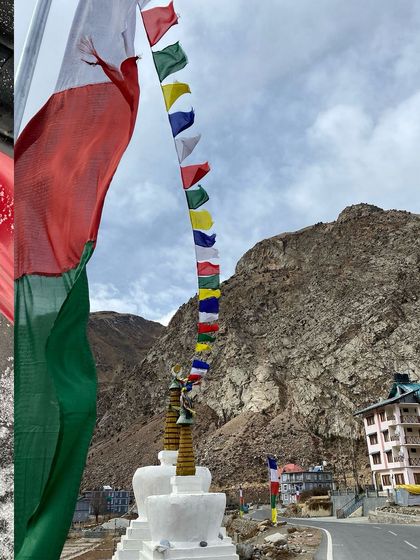 Prayer flags fluttering in the wind against the backdrop of the rocky mountains of Lahaul, Himachal Pradesh.