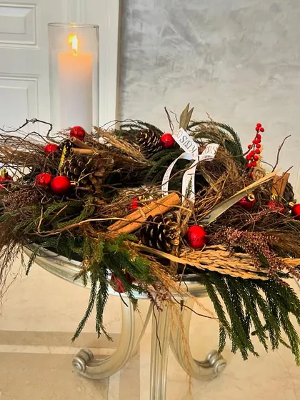 Pines, berries, and twigs create a rustic Christmas feel. This centerpiece, paired with a glowing candle, is perfect for a coffee table or console, bringing a cozy and charming woodland vibe to your decor.