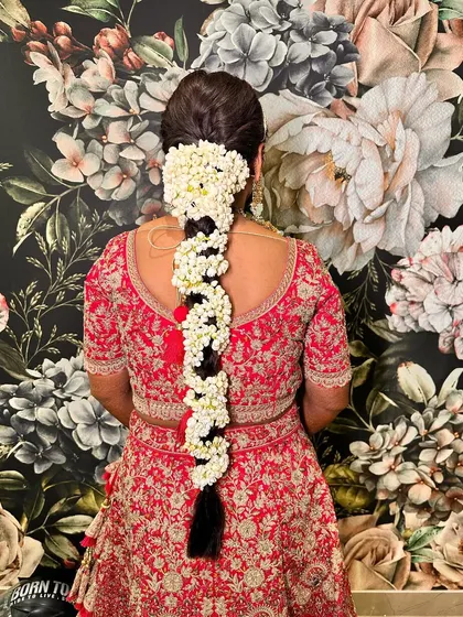 A traditional South Indian bridal braid, heavily adorned with jasmine flowers (mogra gajra) for a classic and fragrant look.
