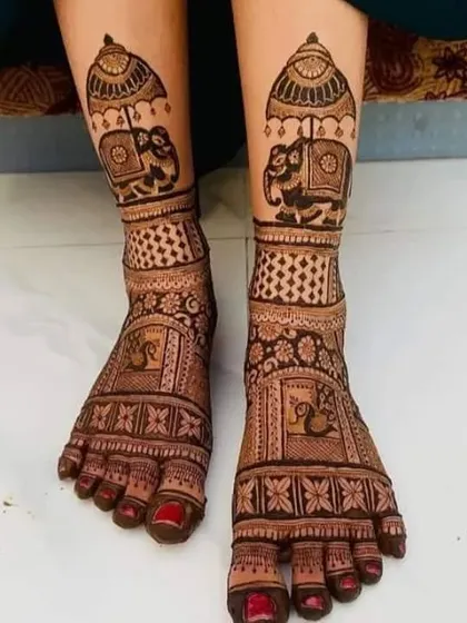 This feet design features royal elephants under an umbrella, matching a popular hand mehndi style for a fully coordinated bridal look.