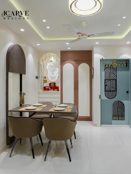 This view shows the dining area in context with the entryway and a custom pooja unit, all featuring matching arched design elements.