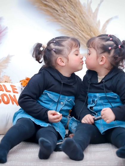 A sweet kiss between twin sisters. These adorable moments of affection make for the most cherished family photos.