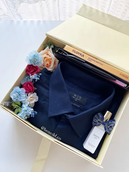 A Father's Day gift box with a classic blue shirt, perfume, and almond brittle. A simple and thoughtful way to show dad you care.