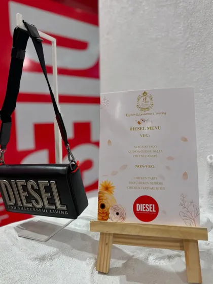 The bespoke menu I designed for the Diesel event, placed next to one of their iconic handbags. This pairing of fashion and food is what makes brand collaborations so special.