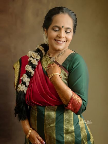 A stunning solo portrait of the mother in her traditional Madisar saree, celebrating 25 years of marriage.