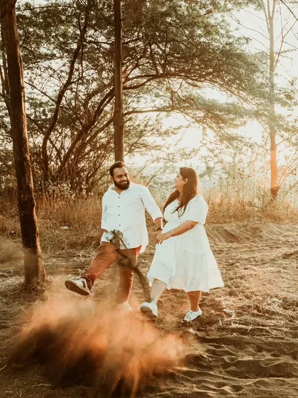 A playful, creative shot where the groom kicks up a cloud of dust, adding action and texture to the photo. We love incorporating natural elements to make our pre-wedding shoots more dynamic.
