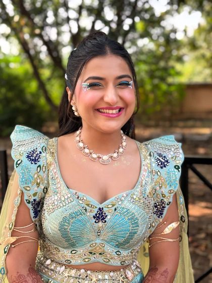 The bride's happy face says it all. The fun, carnival inspired hairstyle perfectly matches her joyful energy and the festive theme of the event.