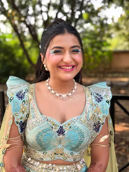 The bride's happy face says it all. The fun, carnival inspired hairstyle perfectly matches her joyful energy and the festive theme of the event.