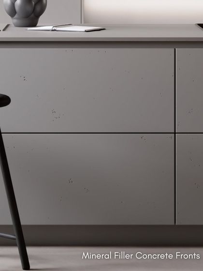 A close-up of our mineral filler concrete fronts. Enriched with stone powder, these fronts feature natural blowholes for a unique, velvety finish that is both durable and stylish.