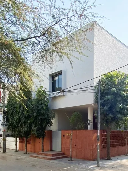 The Jaipur House is a study in modern heritage, where a traditional red sandstone jali meets a minimalist white facade. This project balances cultural context with contemporary living, filtering light and air while paying homage to Rajasthani architectural roots.