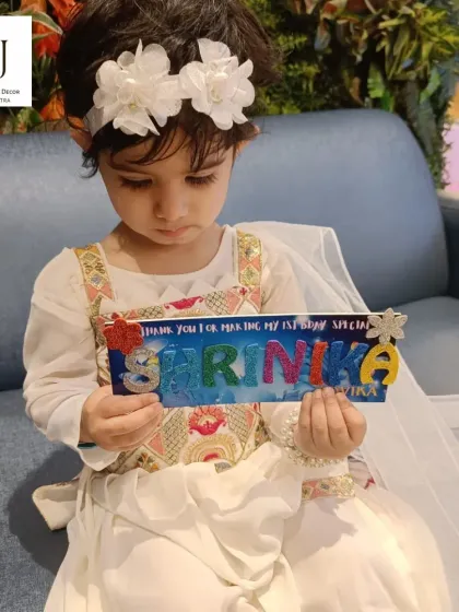 The birthday girl with her custom-made nameplate. We love providing activities that are not only fun but also leave guests with a special memento from the day.