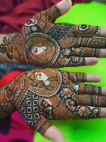 Another example of our custom portrait work, this time on the palms. We can incorporate faces of the bride, groom, or even deities into your traditional bridal henna design.