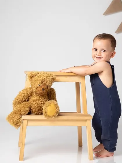 A boy and his bear. This classic, clean studio portrait with a simple step stool and teddy bear is timeless and full of charm.