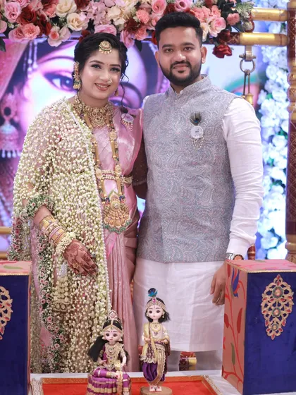 A beautiful couple posing with our gender reveal doll setup before the guessing ritual begins at their baby shower.
