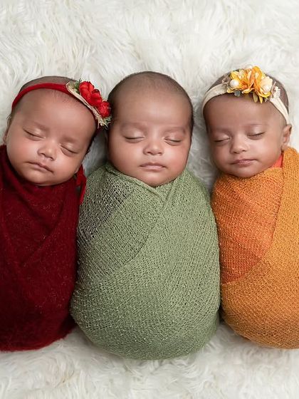 Another beautiful arrangement of the triplet girls, each with their own little floral accessory, showcasing their individual yet connected presence.