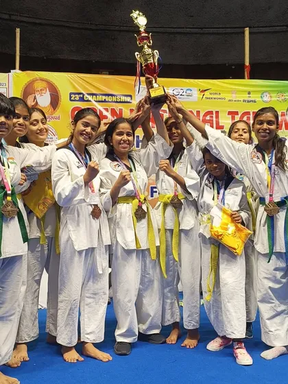 The girls' team celebrating their collective success with the championship trophy.