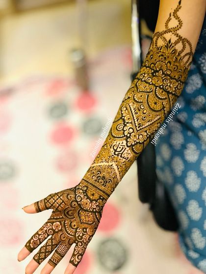 Another angle of Afrah's stunning bridal henna, showing the intricate details and the crown-like motif at the top.