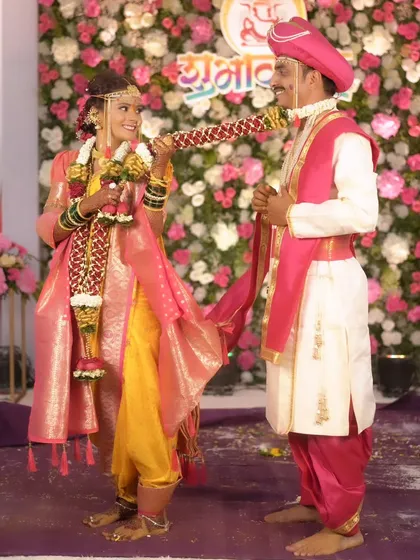 The varmala ceremony, a key moment in the wedding. The bride's makeup is designed to be sweat-proof and long-lasting.