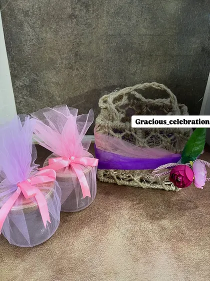 An affordable and cute gifting option. This small jute bag is shown here with two net-wrapped jar candles, but it can be customized for any occasion.