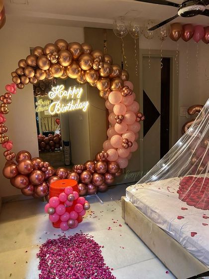 A close-up of the rose gold and pink balloon arch from the romantic room setup.